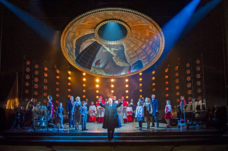 Robert Hayward as Scarpia and the Chorus of Opera North in Opera North’s production of Puccini’s Tosca (Photo credit: Richard H Smith)