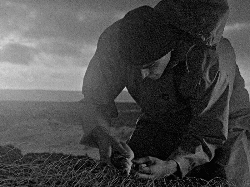 Still from the Early Day Films production, Bait (fisherman fixing his nets). 